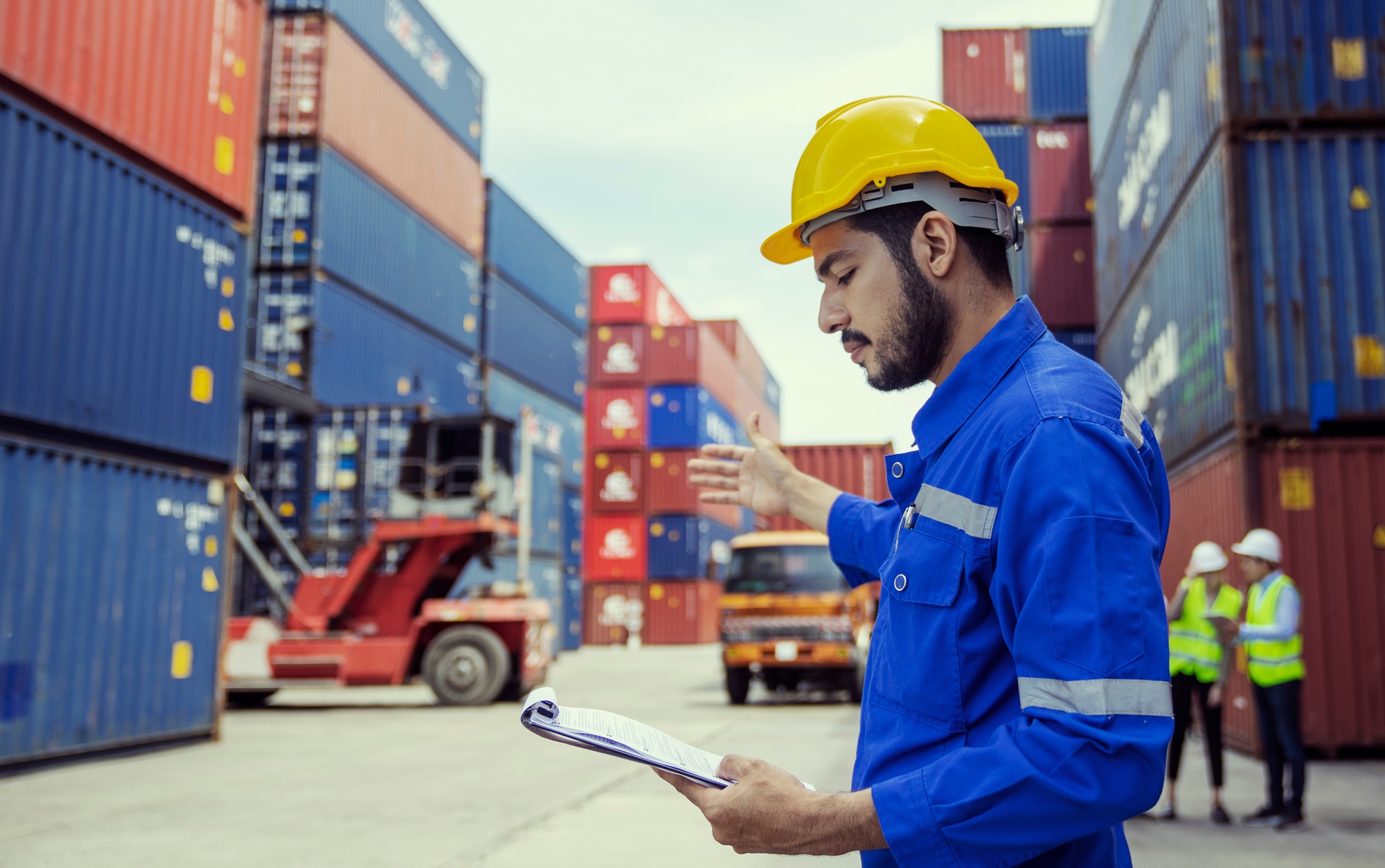 Foremans are discussing for stack container at cargo site logistics service transportation